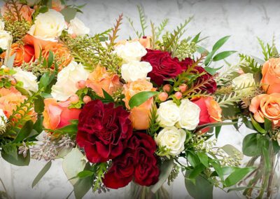 Hailey's Wedding Florals with peach and red roses.