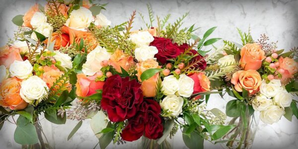 Hailey's Wedding Florals with peach and red roses.